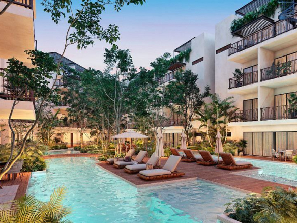 Dos piscinas y terraza de madera solarium en el medio, rodeada por un edificio residencial blanco en Costa Caribe