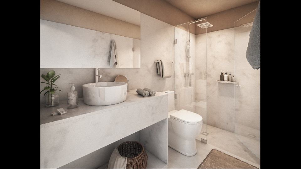 Salle de bains blanche avec cabine de douche en verre dans les appartements Koh