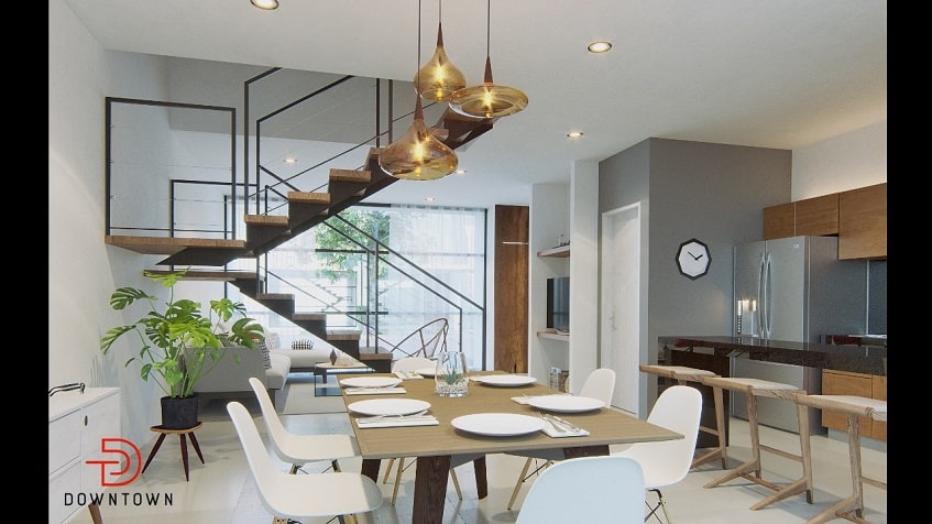 Interior de casa con gran mesa de comedor y escalera en Downtown de Tulum