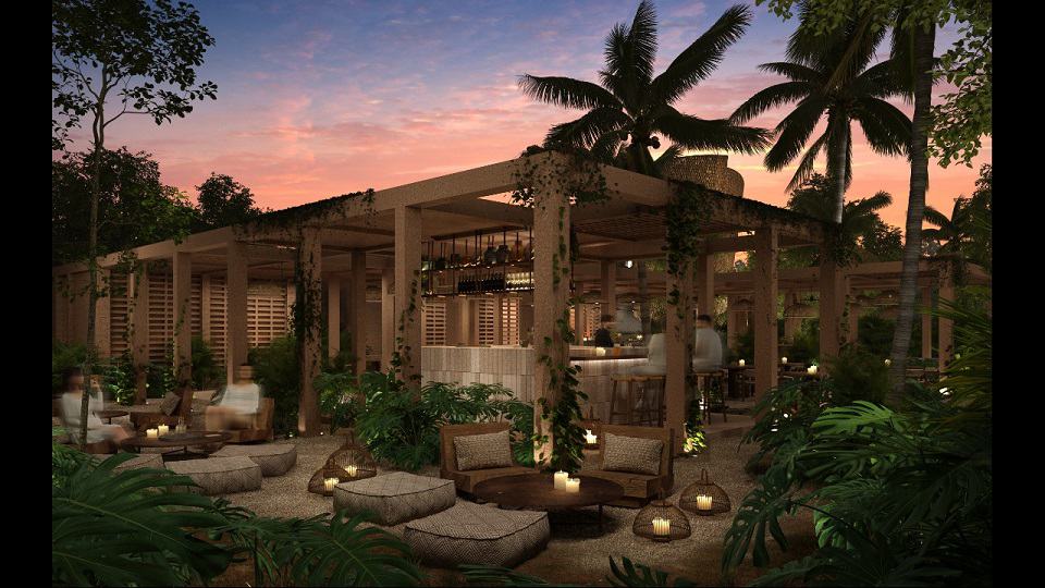 Vista nocturna de un restaurante al aire libre y decoración de velas en Aflora Tulum