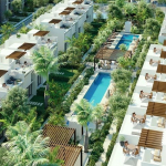 View of a residential area with row houses and a pool in downtown Tulum.