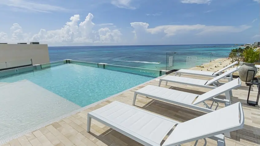 Swimming pool with lounge chairs at IT Beach Playa del Carmen