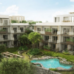 Piscina en el jardín y edificio residencial blanco de cuatro niveles en Erena Mindful Apartments