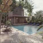 Ground-floor pool and lounge area at Home Tulum