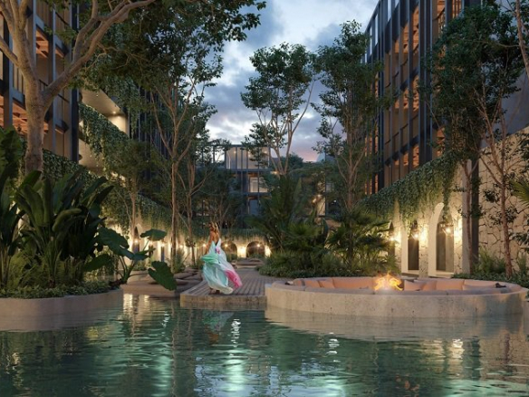 Ground-floor pool between two residential buildings surrounded by vegetation at Hacienda Tuk