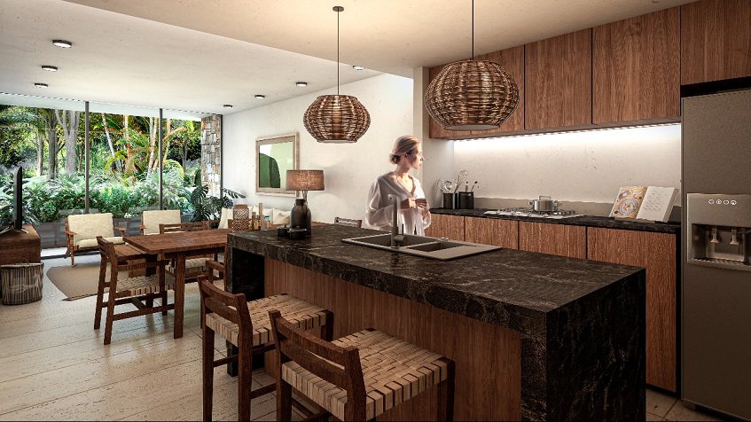 Cocina con barra de desayuno y fregadero con una mujer de pie junto a Kante Apartments