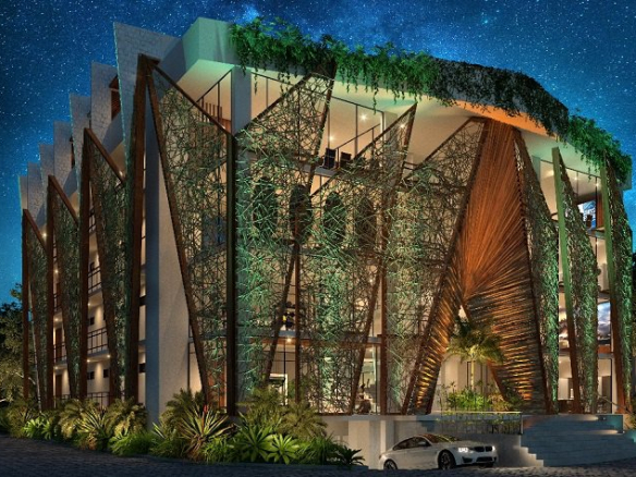 Illuminated building facade with a car leaving the underground parking lot in Akua Tulum