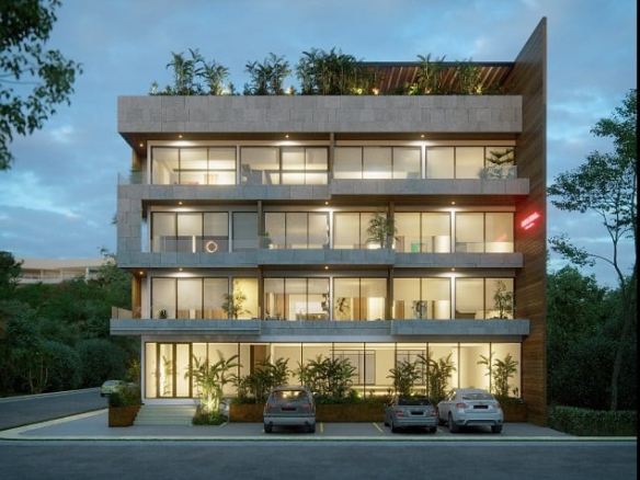 Vista de la fachada frontal del edificio residencial desde la calle en Helena Tulum Luxury Homes