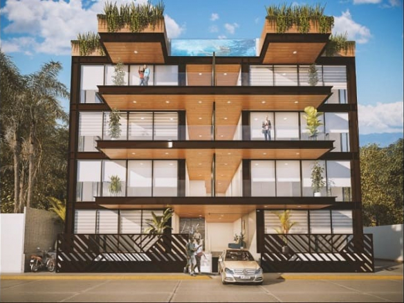 Facade of a five-story building and a car leaving the underground parking lot at Loft Playa