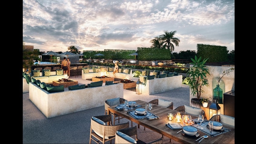 Gran área de fogata junto a la piscina y gran mesa de comedor en Amelia Tulum