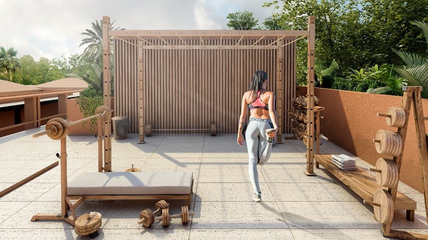 Gimnasio al aire libre con pesas y escaleras para colgar y mujer haciendo ejercicio en Kante Apartments
