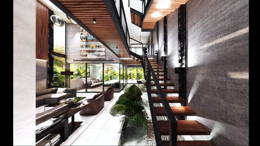 Escalera larga de madera y metal en el interior de la casa de Aldea Paraíso