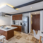 Kitchen with a hood over a stove top island in Zilha 42 Condominium