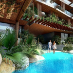 Central courtyard and two couples walking by the pool at Menesse Tulum