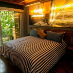 Bedroom with two double beds next to the high window in Residencia Condos