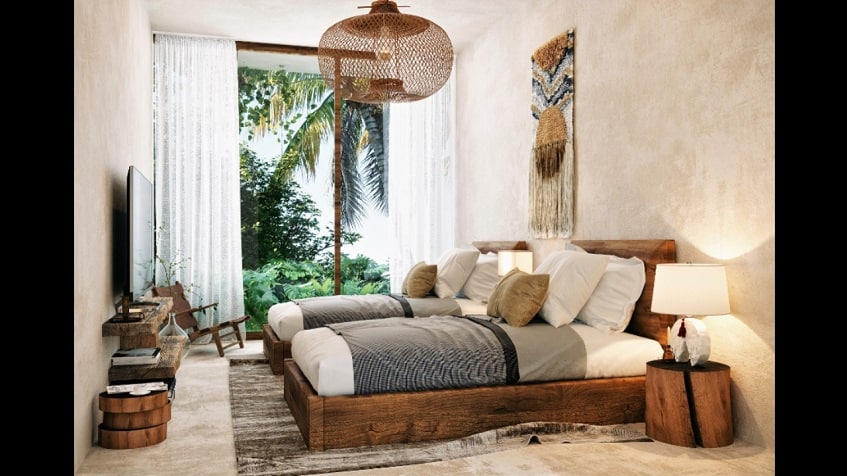 Dormitorio con dos camas individuales frente a la pantalla de tv y ventana alta con vista al jardín en Amelia Tulum