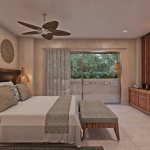 Grande chambre à coucher avec lit king size devant l'écran de télévision sur le mur brun et la terrasse à Toh Living Playa del Carmen.