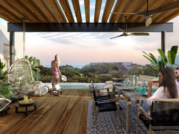 Azotea con piscina y personas sentadas a la mesa en SAK Condo Hotel