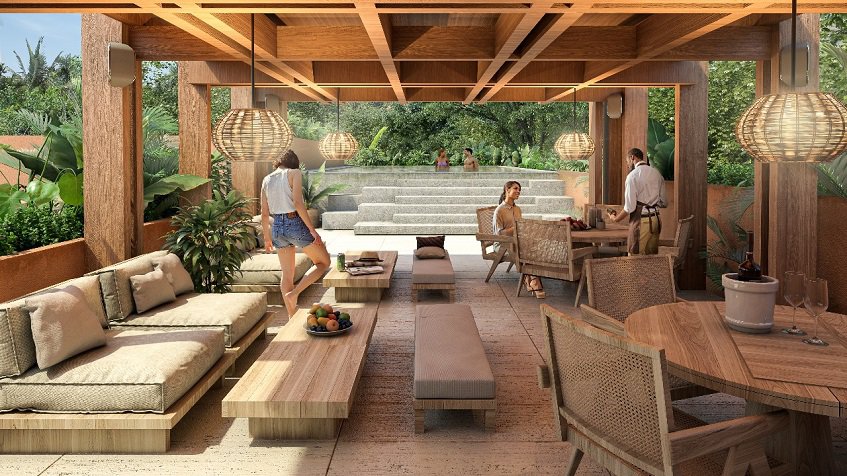 Área de descanso con personas y piscina al fondo en Kante Apartments