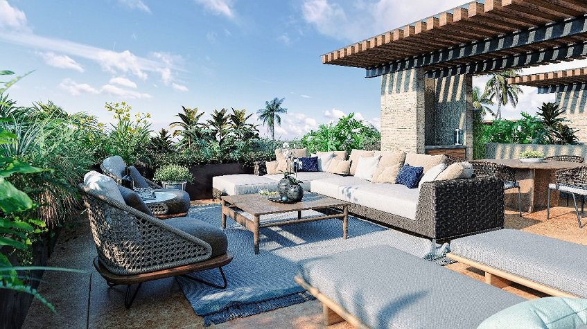 Terraza en la azotea con sala de estar rodeada de plantas verdes en Aleda Playa
