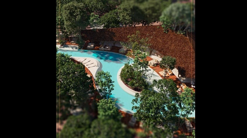 Piscina en forma de río con solárium en Mirador Tulum