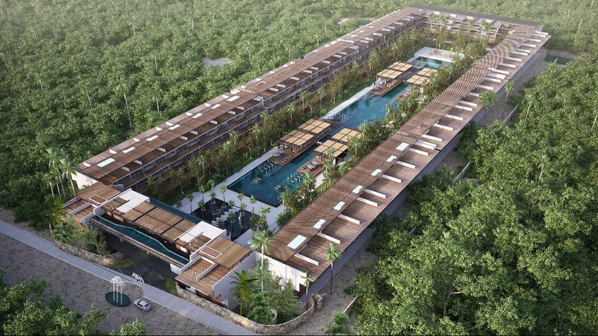Vista superior de la piscina extra grande rodeada de edificio residencial en Awa Playacar Residences