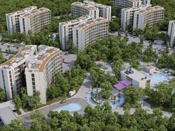 Few residential buildings and clubhouses with pools in the middle of La Ceiba, Mayakoba City