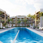 Piscine avec pataugeoire à l'intérieur du condominium à Xhelin Playa del Carmen