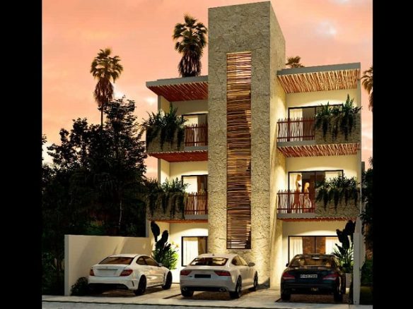 Facade of a three-story building just after sunset at Kamil Ha II Tulum