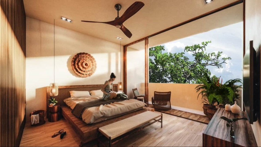 Bedroom with woman reading a book on the bed in Bacab Tulum