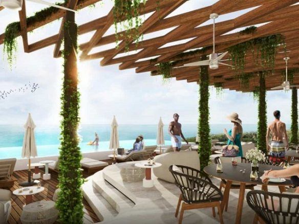 Club de la azotea con gente relajandose en Ixuh Beach Living