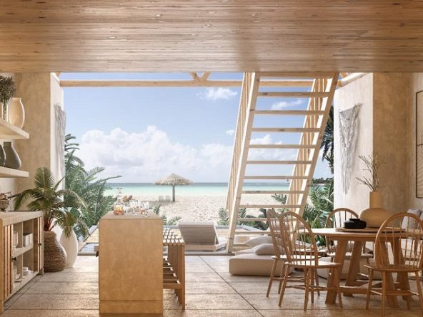 Sala con pared abierta y escaleras de madera con terraza y vista a la playa Costa Residences & Beach Club