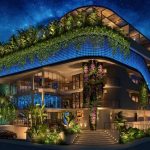 Fachada del edificio de propiedad rodeada de vegetación en Rio Aldea Zama