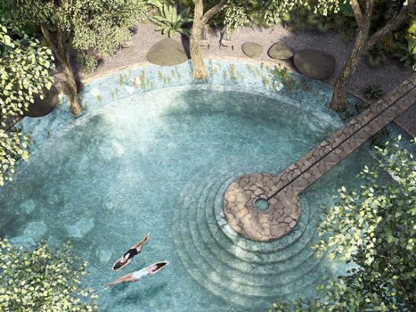 Vista superior de la piscina redonda en el jardín y dos mujeres nadando en Beecheii