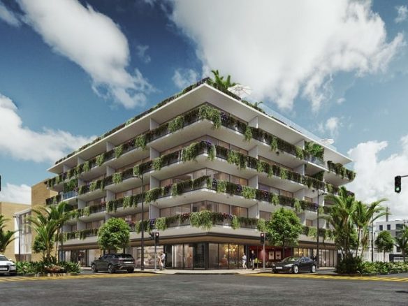 Esquina de edificio residencial blanco con vegetación en Sensai Downtown