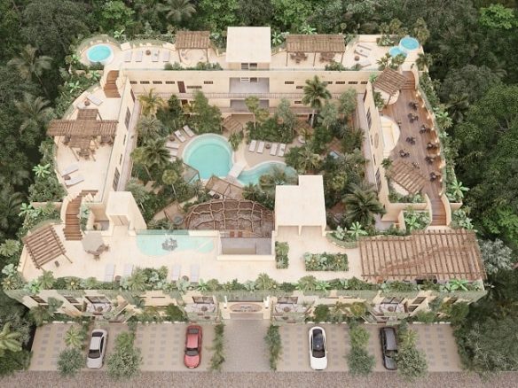 Fachada de edificio residencial en forma cuadrada y alberca en medio en Elemental Tulum