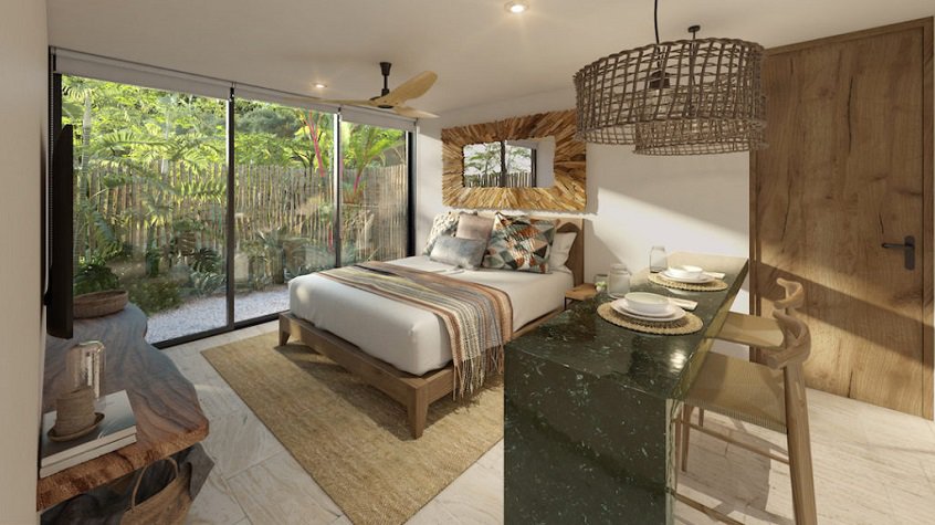 Estudio con cocina y cama al lado del ventanal, terraza detrás en Estela Tulum