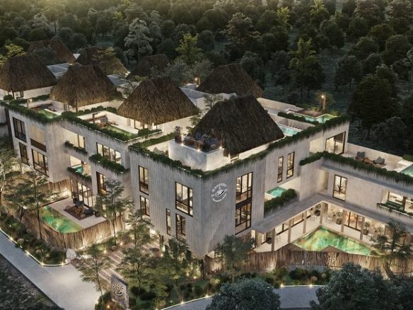 Vista superior del edificio residencial con palapas en los techos y alberca en planta baja en Mestiza Tulum