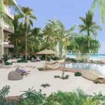 Pool on the beach surrounded by palm trees at Kaoba Tulum