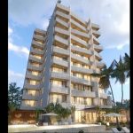 Nine-story high-rise residential building surrounded by vegetation in the Puerto District