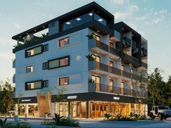 Vista de esquina de edificio residencial con locales comerciales en planta baja, horario nocturno en Lik Zama