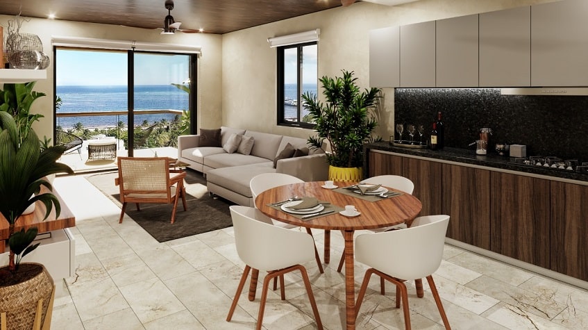 Cocina y mesa de comedor redonda, sala de estar y vista de ventana para un balcón terraza en Porto Blu Puerto Morelos