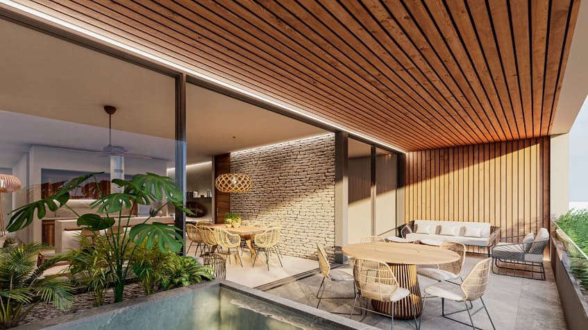 Pool terrace with table and another dining table at Nygma Tulum