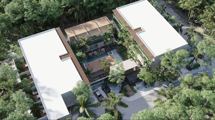 Vista aérea del complejo de edificios residenciales, piscina en el medio en Nygma Tulum