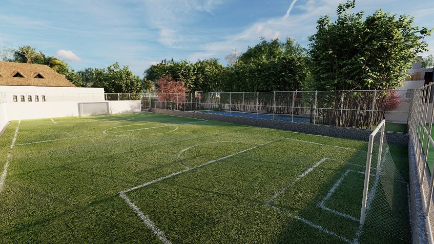 Green soccer field surrounded by a fence in Bali in Riviera Maya