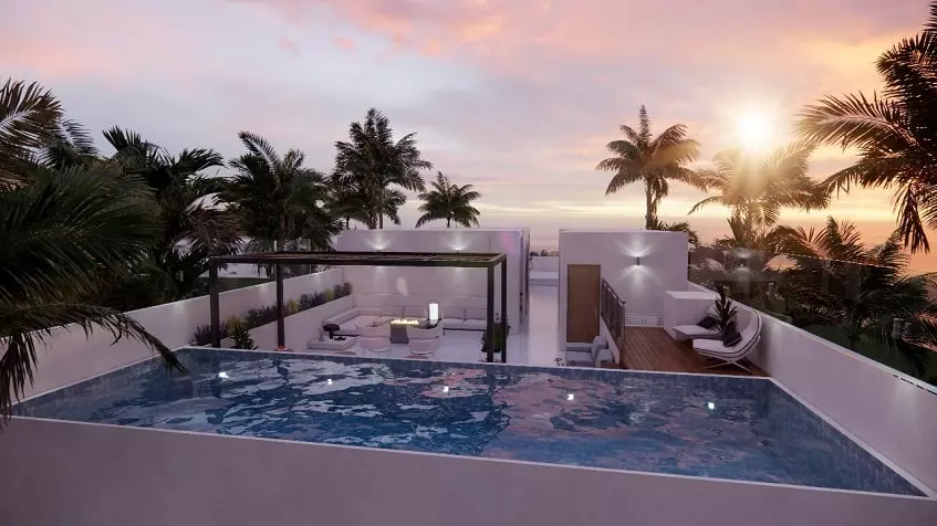 Rooftop pool and lounge area during sunrise at South 307 Condominiums