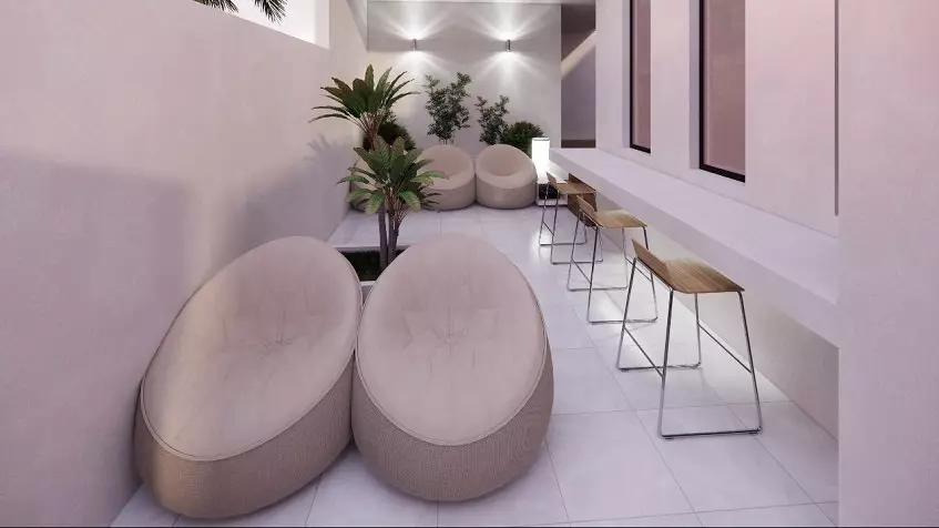 Tall stools next to white long bench, beanbag chairs in South 307 Condominiums.