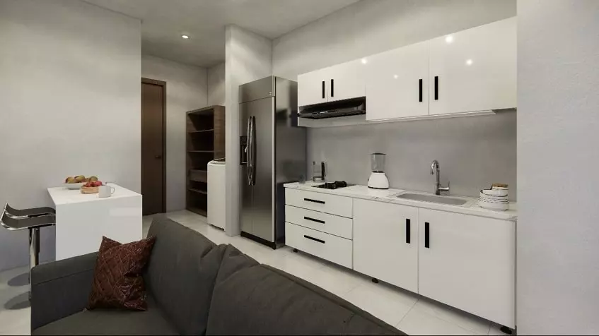 White kitchen with breakfast bar, dark sofa in South 307 Condos