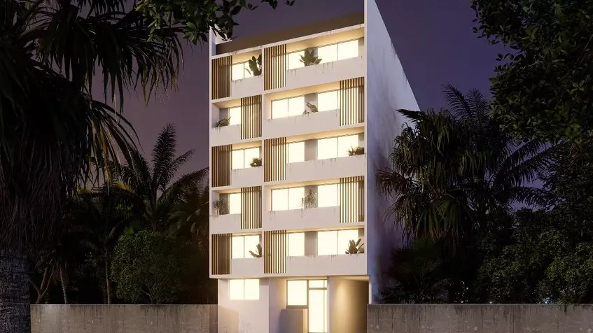 White residential building façade at night in South 307 Condominiums