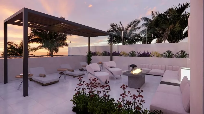 Sofas and lounge chairs around a rooftop fire pit, pergola in South 307 Condos